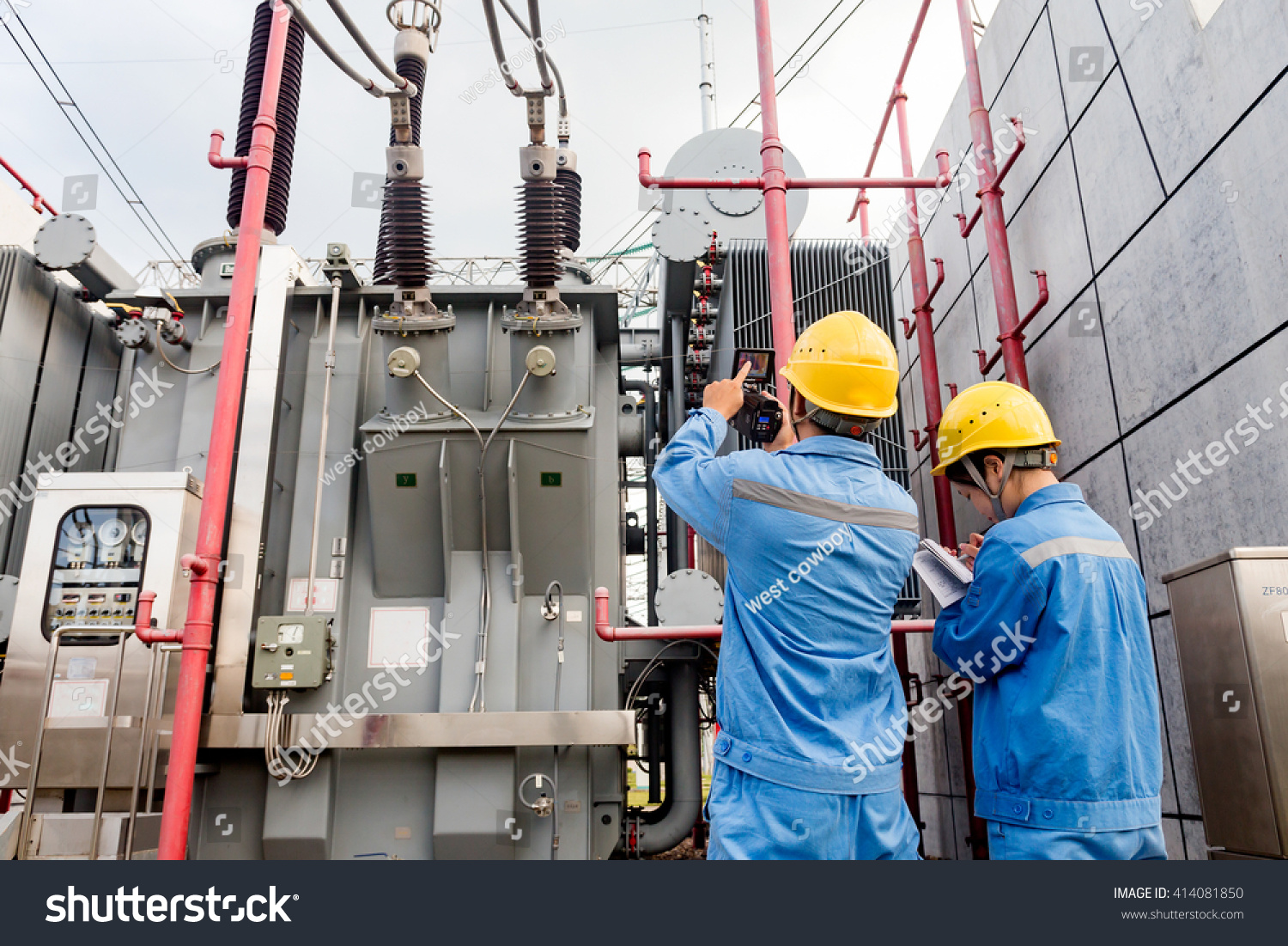 stock-photo-workers-use-instrument-testing-power-equipment-414081850